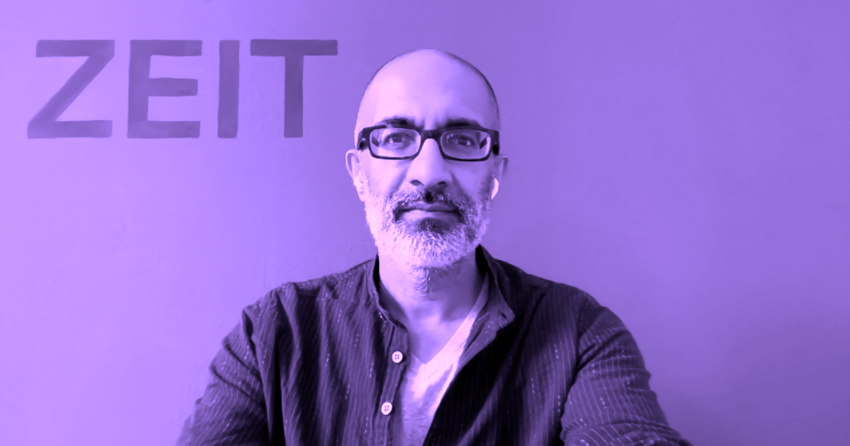 headshot with the word ZEIT painted on a wall in background